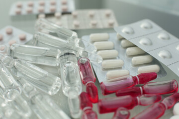 Tablets pills ampoules on a glass table