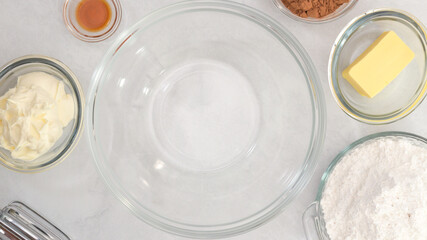 Chocolate buttercream icing preparation process. Ingredients close up on kitchen table, top view