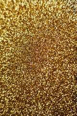 Gold dust background blurred, small gold dust reflects light