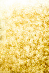 Gold dust background blurred, small gold dust reflects light