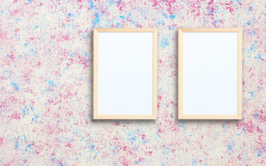 two empty rectangular frames on a color wall.