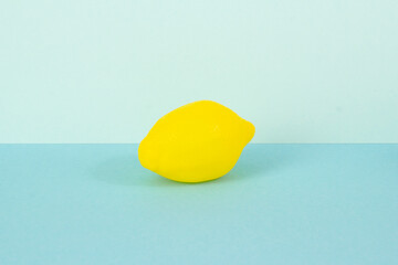 Plastic fake lemon on a blue background