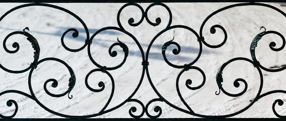ornament forged metal decorative pattern on a background of snow