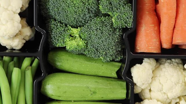 Fresh organic vegetables. Top view of Pumpkin, Broccoli, Bean, Cauliflower vegetables. Slow motion.
