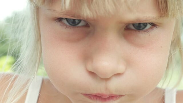 Close up portrait blonde little girl looking sad disappointed caucasian kid grumpy upset