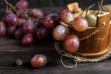 Rural still life with grapes on wooden table