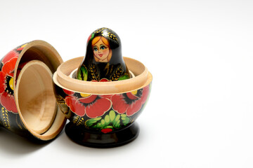 Disassembled Russian nesting doll. The upper part lies on the side, and a small doll stands inside...