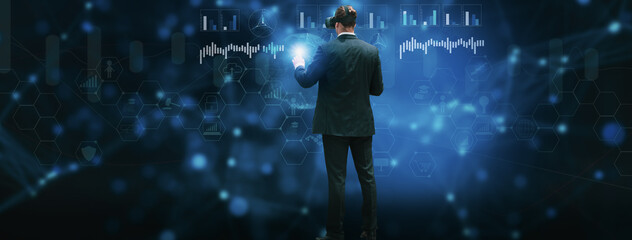 Businessman using vr glasses headset to analyze and process operations using artificial intelligence or AI system,concept futuristic innovation and technology,internet of Things or iot,big data