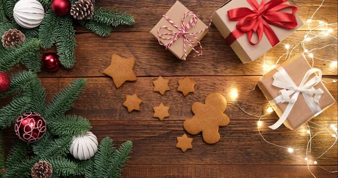Time lapse putting gingerbread cookies on wooden table. Christmas, festive New Year background with holidays baked biscuits. Top view