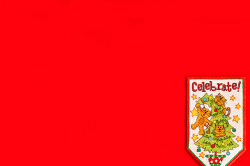 Christmas background with embroidered new year flag on red background, holiday, new year and Christmas concept. holiday. cats on the Christmas tree, a fun holiday picture