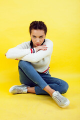 lifestyle people concept: pretty young school teenage girl having fun happy smiling on yellow background