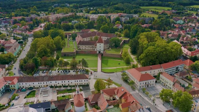 Sarvar, Hungary - 4K drone flying above the famous Castle of Sarvar (Nadasdy castle) on a sunny summer day with green trees and blue sky. The town of Sarvar has been located in Vas county