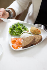 Woman having poached egg