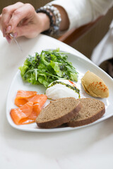 Woman having poached egg
