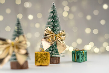 decorative Christmas trees decorated and gifts for the new year on the bokeh background, new year mood 2021