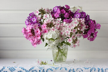 bouquet of Phlox in a glass vase on the table.