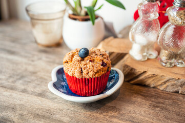 Homemade baked blueberry muffin on wooden table