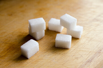 sugar cubes on a wooden background