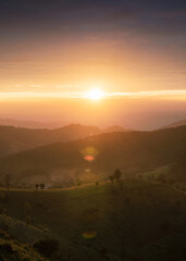 Sunrise on agricultural hill in countryside at Doi Mae Tho