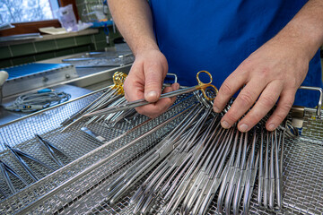 some Cleaned surgical instruments are sorted into an instrument tray