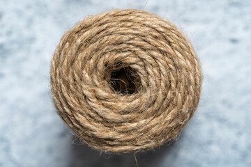 High-quality handmade coil made of natural hemp rope, isolated on a white background. Rustic beige...