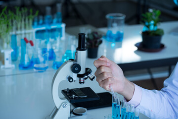 Fototapeta premium Asian medical scientist doctor wearing surgical protective face mask and lab gown analysis virus vaccine in clinical laboratory. healthcare and medicine concept. virus pandemic concept. 