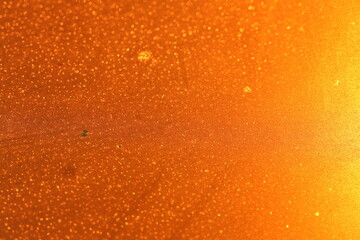 The glass is illuminated by the sun at sunset