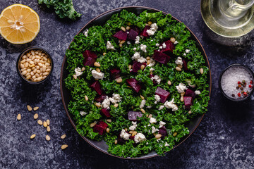 Healthy raw kale and beetroot salad with feta cheese and pine nut.