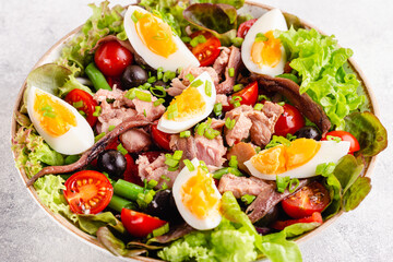 salad Nicoise with tuna, eggs, green beans, tomatoes,  olives, lettuce and anchovies