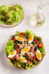 salad Nicoise with tuna, eggs, green beans, tomatoes,  olives, lettuce and anchovies