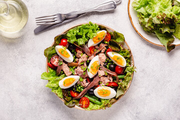 salad Nicoise with tuna, eggs, green beans, tomatoes,  olives, lettuce and anchovies