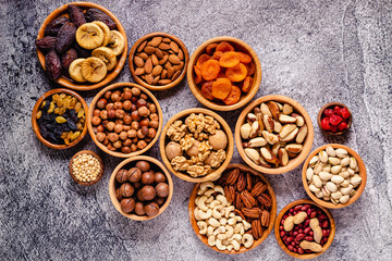 Various Nuts and dried fruits in wooden bowls.