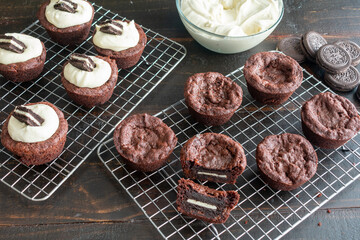 Oreo Stuffed Brownie Cups: Brownie cups filled with a sandwich cookie and topped with frosting on a...