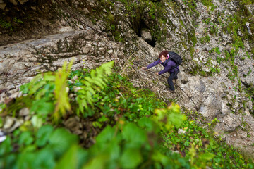 Obraz premium Tourist woman hiking in the mountains