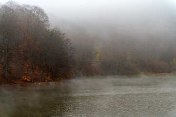 Fog covers the forest by the blue lake in Kabardino-Balkaria.
