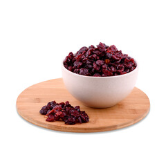 Dried cranberries in white bowl on wood board isolated on white background, copy space.