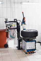 Car wheel on tire replacement machine in workshop, stock image