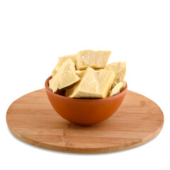 Cocoa oil in brown bowl on wood board isolated on white background; copy space.