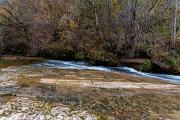Autumn landscape with mountain dry brook and forest