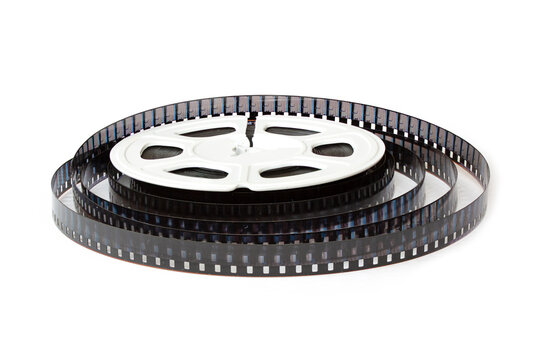 8mm film reel with film strips scattered around. Close-up image isolated on white background.