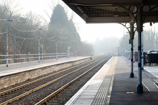 Landscape photograph of a foggy morning train station in England near London.