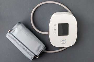 Automatic blood pressure monitor on gray background. Medical electronic tonometer