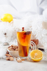 Christmas tea with spices on a white table.