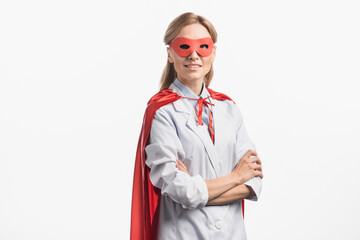  nurse in superhero mask and cloak standing with crossed arms isolated on white