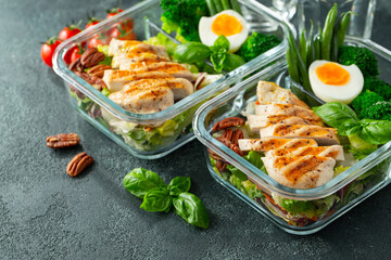 Healthy meal prep containers with green beans, chicken breast and broccoli. A set of food for keto...
