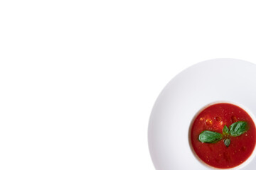 Italian Tomato Soup With Basil In White Bowl In The Corner. Isolated White Background. Top View.