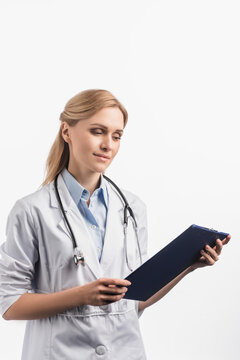 nurse in white coat looking at clipboard isolated on white, stock image