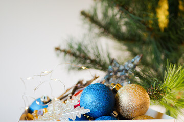 Christmas ornaments in box. Decorating pine tree. Holidays preparation. Copy space. New Year atmosphere 