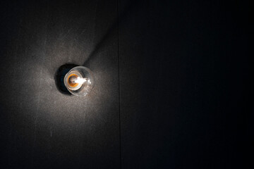Background image of dark wall with lamp above.
