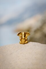 Bronze statuette of the Indian god Ganesha on nature background